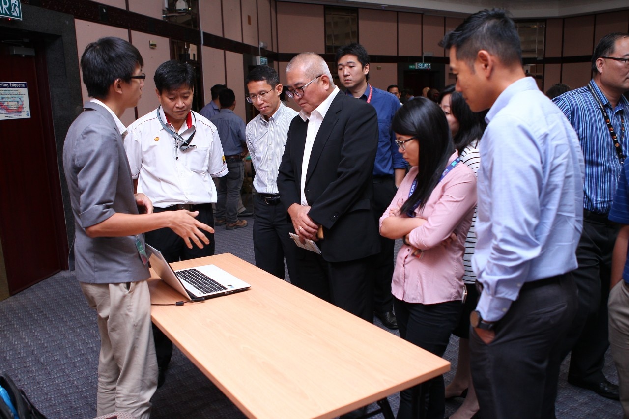Jeff Wee, of WormingUp, presenting his idea to Adam Yii, Mayor of Miri City (in black)