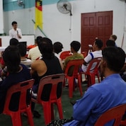 Haaziq explaining sustainable fishing practices to the Kuala Sibuti fishing community in Sibuti, Sarawak.